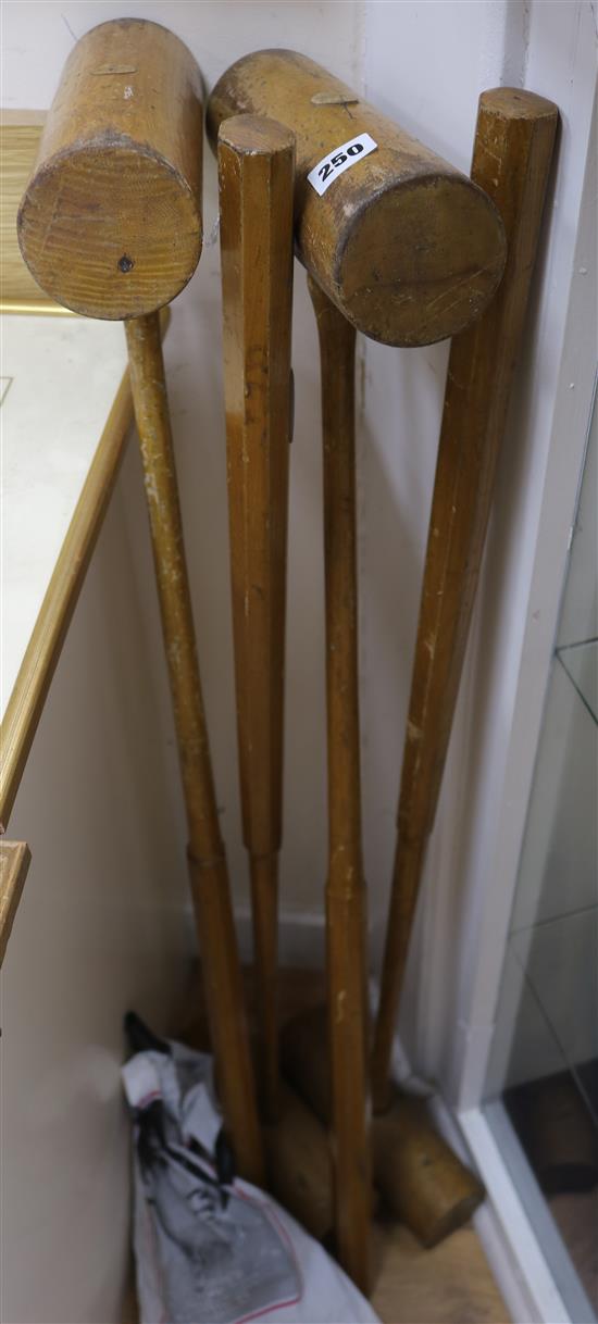 Four croquet mallets and four balls